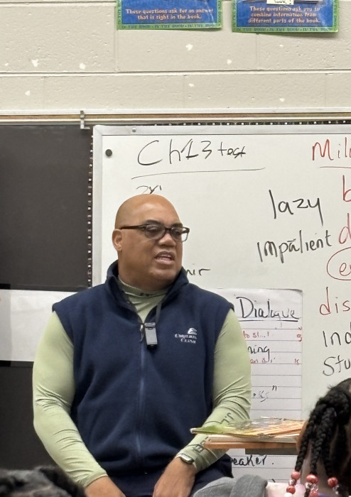 Supply Chain Manager Forrest Irving reads to 3rd grade class