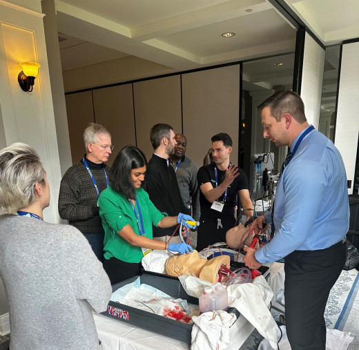 Emergency Medicine physicians train to perform cricothyrotomy.