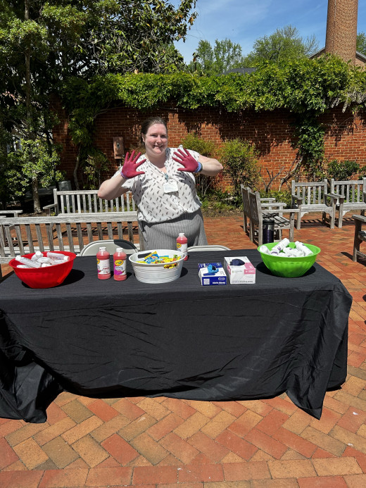 Infection Preventionist, Bray Studtmann, using "Caught Red Handed" activity to educate students on proper hand washing technique/