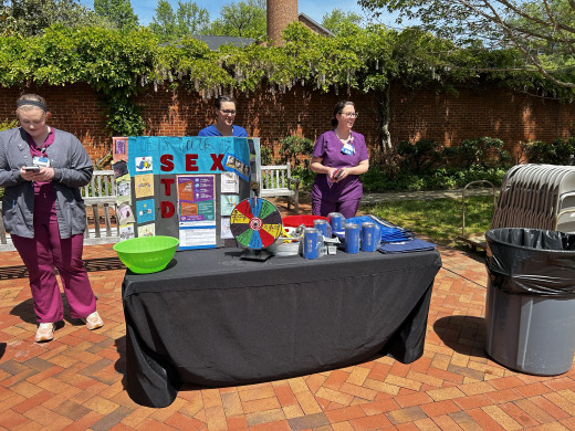 Infection Preventionists, Kathleen Manchin and Halie Mahoney, educated students on sexual health and STD prevention by adding sex ed questions to a spinning wheel and allowing students to spin and answer questions. 