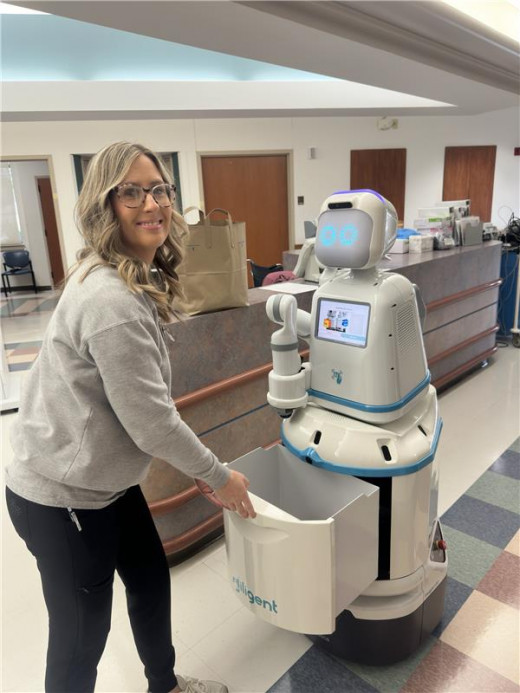 Staff member with Moxi