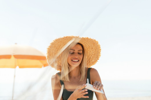 Woman applying sunscreen.
