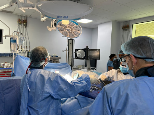 Drs. Adhikari and Marvin (foreground) demonstrating the technique of kyphoplasty