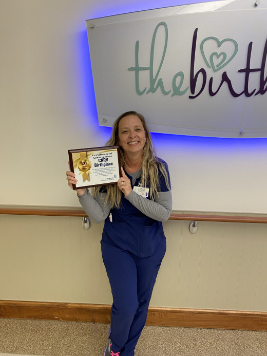 Rhonda Lamber poses with recognition plaque 