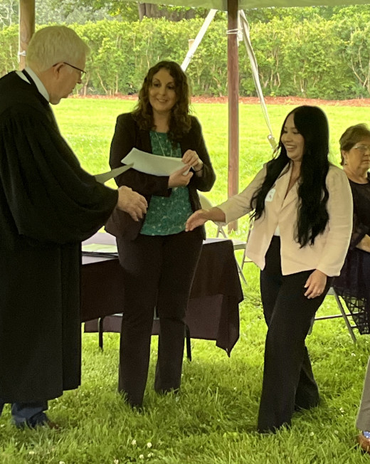 Arlette receiving her Citizenship Certificate from Judge