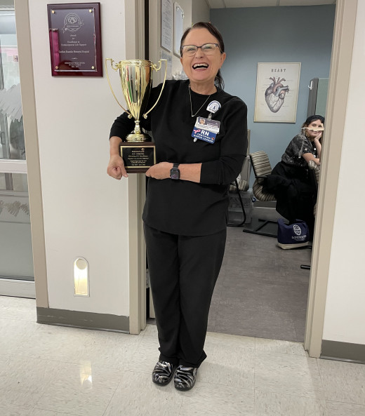 CVI Surgery ICU Unit Director Kristy Massey holding the ICU Strong Trophy