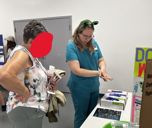 Ashley giving participant feedback on hand washing 