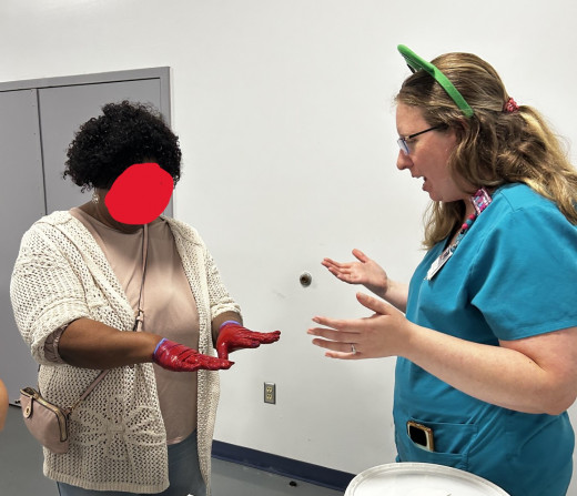Participant using red pant to test their hand washing skills