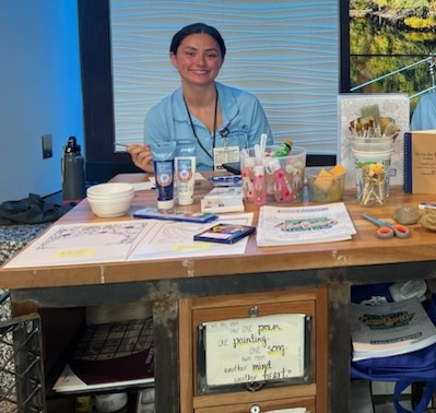 Student Volunteer, Hannah Mizuba, with the Keeley Healing Arts Program's Art Cart