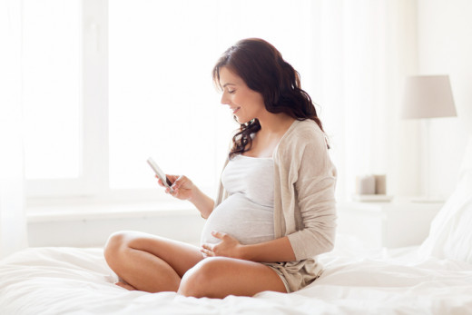 pregnant woman looking at app
