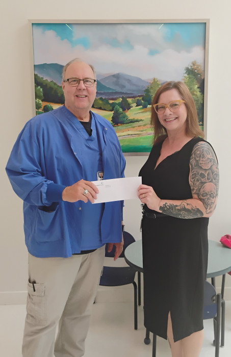 Dr. Lee Jones receiving his gift card from the IRM Team