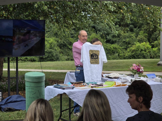 Dr. McMahon holds a 50th Anniversary CGCH T-shirt