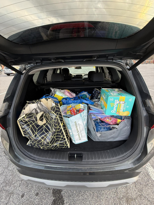 SUV with tote bags in truck that contain donations. 