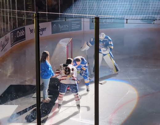 Tonie Bailey, a team lead in Home Care, performing the ceremonial puck drop to start the game.