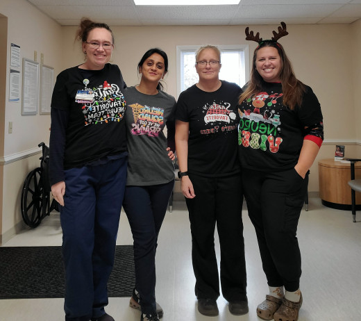 Image of 4 women with festive holidays shirts with different sayings.