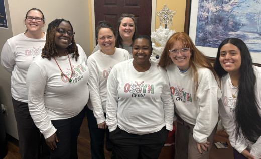 A group of smiling coworkers coming together in matching shirts reflect teamwork, dedication and the heart behind what we do everyday. It's a reminder that great work happens when people support and uplift one another.  Happy Holidays from the SALEM OBGYN Crew! 