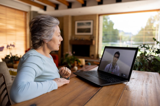 senior woman listening to physician during telehealth visit
