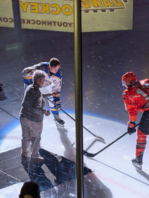 Avis Reynolds dropping ceremonial puck for CVI Night at the Railyard Dogs game.