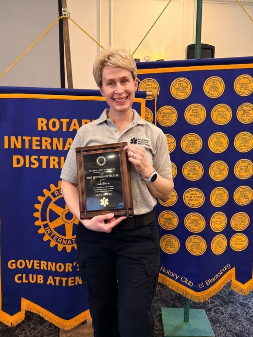 Photograph of Catie Davis, IPR liaison supervisor, with her plaque for First Responder of the Year.