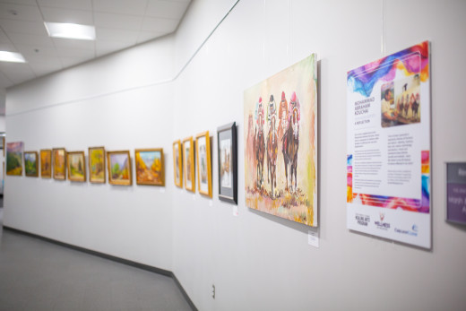 Mohammad Kouchai's exhibit, "Displaced Artist: A Reflection" lines the hallway at Melrose Plaza