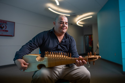 Gallery Artist, Mohammad Kouchai, plays the rubab, a classical instrument in Central Asia