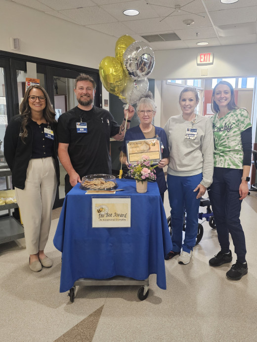 Wanda (middle) and CCU leadership and co-workers.