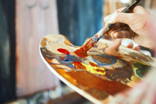 paint brush and palette of colorful paint