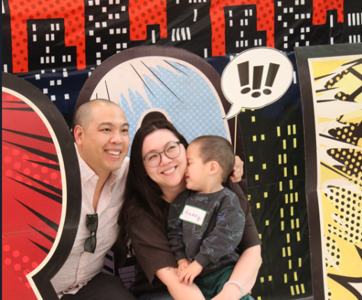 NICU Family Posing at a backdrop 