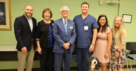 Jeremy Howard surrounded by Oakey's staff and hospice leaders, Sherrie Agee and Heather Hurd.  