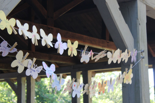 Paper butterflies hanging on a line with names of the children we remember and honor. 