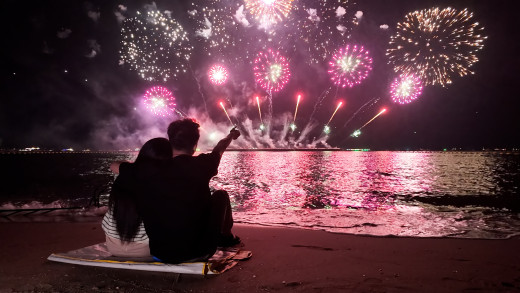 couple watching fireworks on a lake