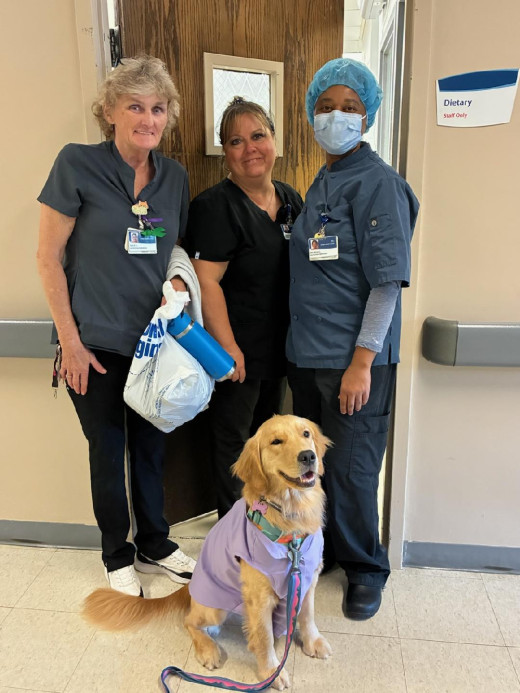 Meadow visits with the dietary team at Tazewell