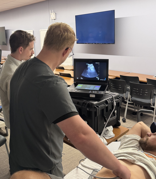 Chief resident Ryan Corlett teaching interns Austin Murray and Jacob Nelson