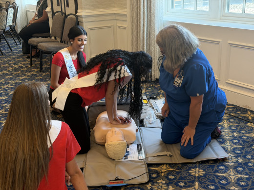 Miss Virginia pageant contestants practicing CPR with Wendy Meador, RN