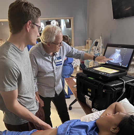 Dr. Mike Jones teaching ultrasound-guided techniques to interns Nick Wright and Taylor Keys