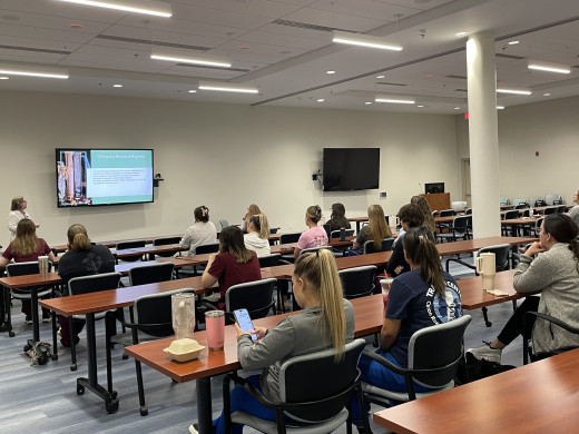 Dr. Chris Fish Huson shares expertise on evidence-based practice with Nurse Residents during an interactive classroom session.