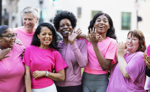 group of people wearing pink shirts